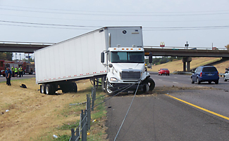 Semi truck over median.