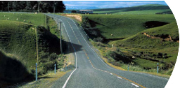 Open road through green hills.